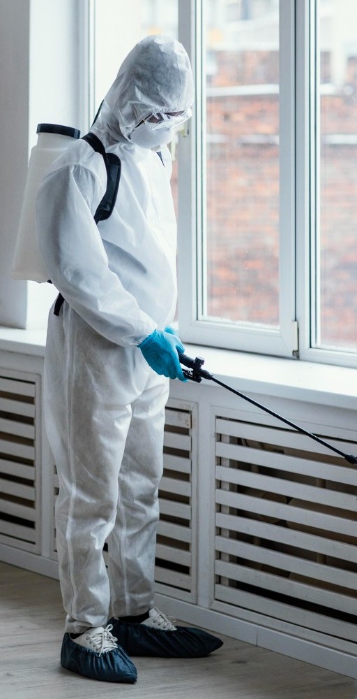 Sukhmani Pest Control technician spraying indoors